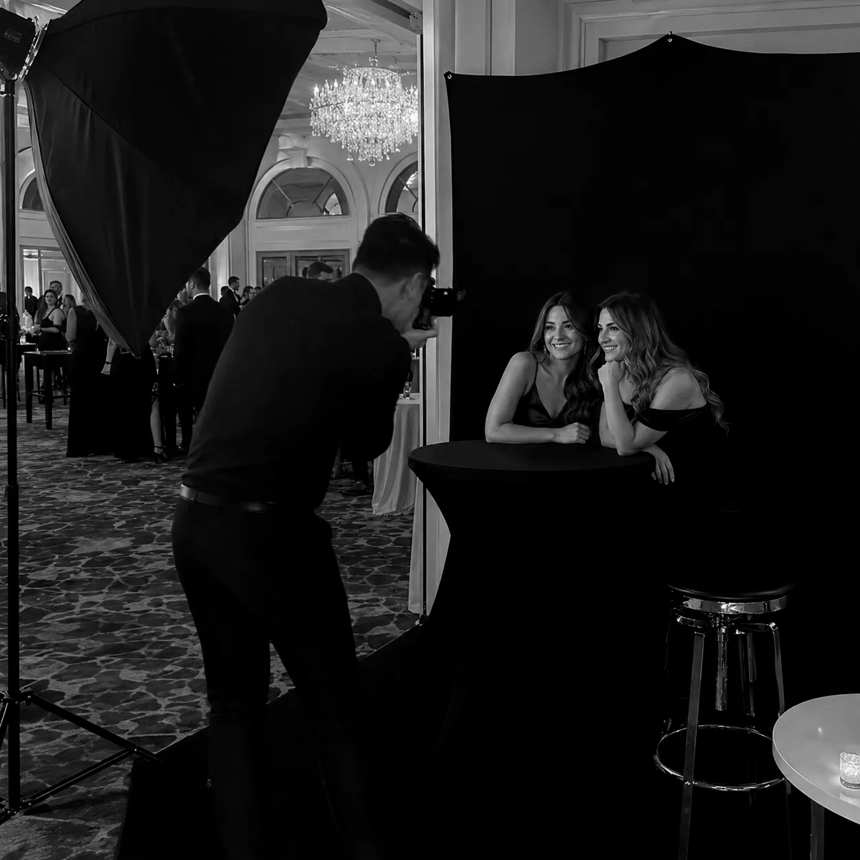 Behind the scenes portrait session with black backdrop and studio lighting