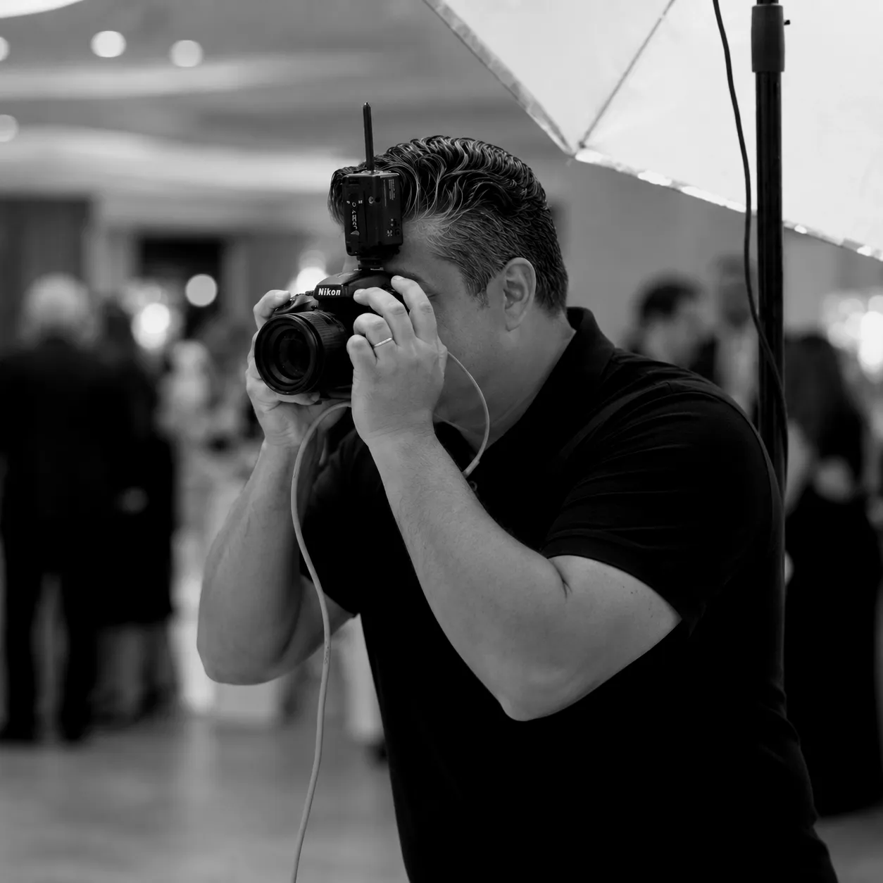 Gonzalo photographing guests at an event under studio lighting